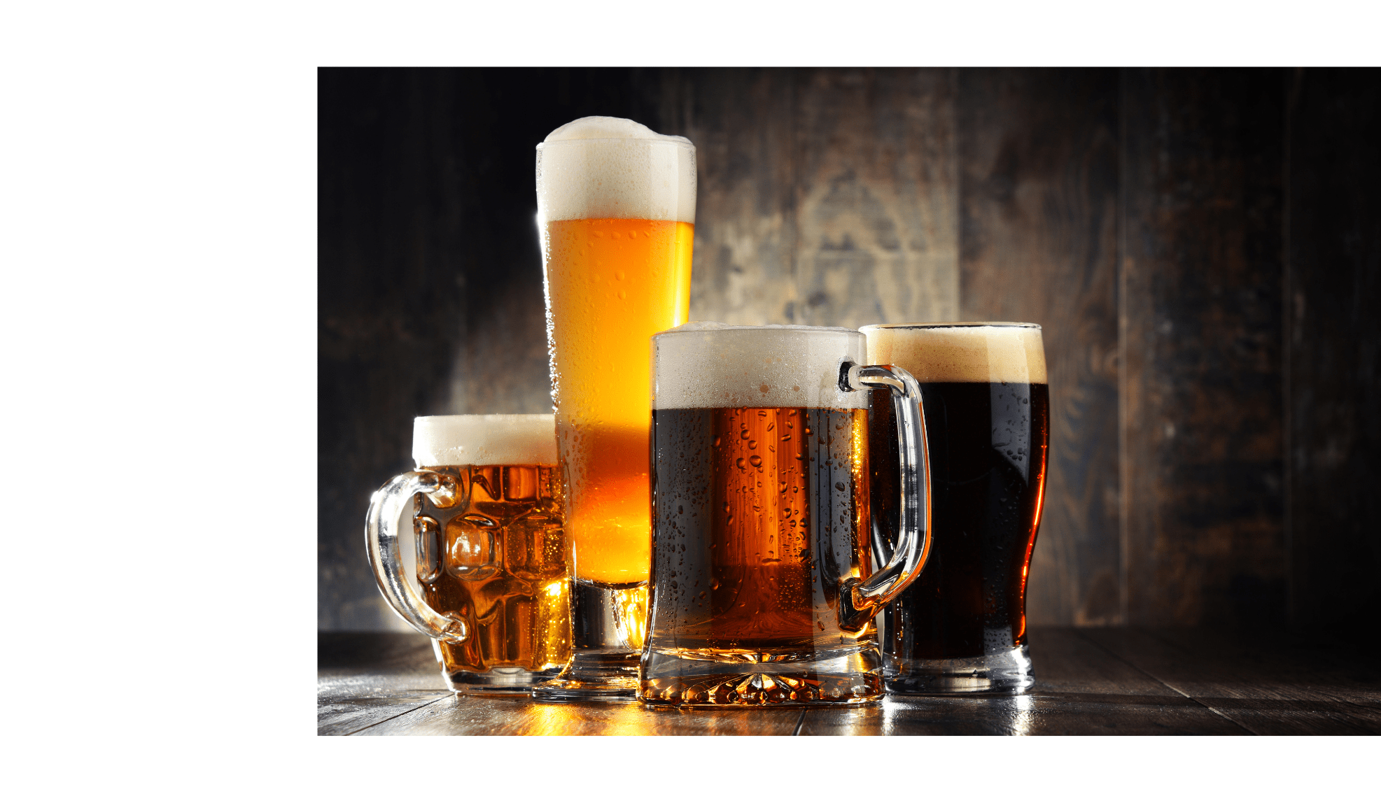 Four glassed of beer on wooden background